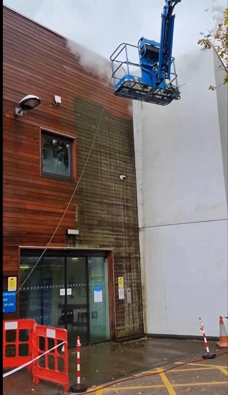 A crane is lifting a building into the air.